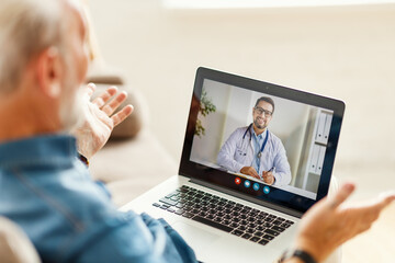 Senior man speaking with online doctor.