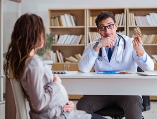 Pregnant woman visiting doctor for consultation