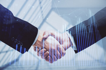 Double exposure of forex graph hologram and handshake of two men. Stock market concept.