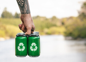 Man holding cans with recycle symbol. Recycling concept