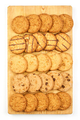 Sweet cookies on the wooden cutting board. Gluten-free oatmeal cookies on pure white fabric