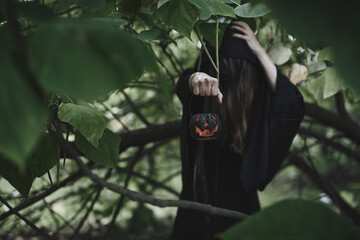 Witch preparing for a ritual in the forest