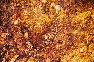 Flat organic rock surface, rusty red and beige.