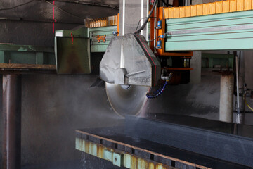 Process of cutting a granite workpiece on a bridge stone cutting machine.