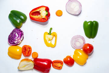 Fresh colorful vegetables in a cut on flat lay white background pattern from vegetables
