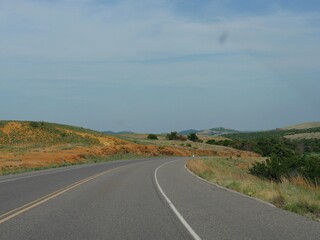 Wide view of a winding road around the Wichita Mountains in Oklahoma.