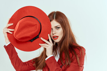 beautiful woman in red hat blazer makeup elegant style light background studio