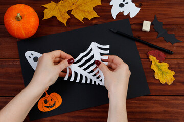 Halloween DIY. Step-by-step instructions for cutting a spider web from paper for the holiday.