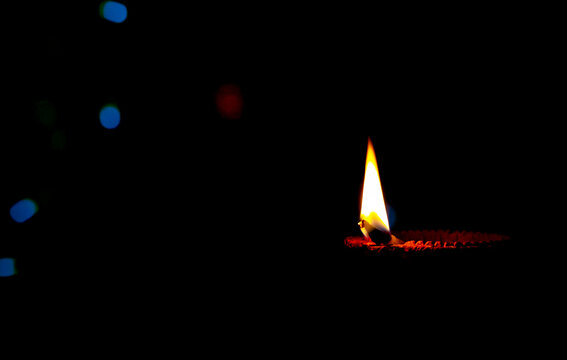 Traditional clay oil lamp on dark background, copy space.