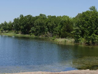 View of a lake seen from the road at Chickasaw National Recreation Area in Davis, Oklahoma