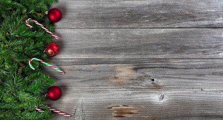 Merry Christmas and Happy New Year theme with holiday decorations on left side of weathered wooden boards