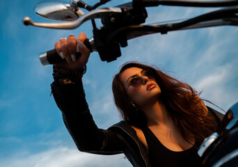 Closeup attractive woman holding hand throttle on motorbike