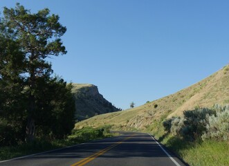 Scenic drive along a paved road at Yellowstone National Park heading toward Gardiner, Montana.