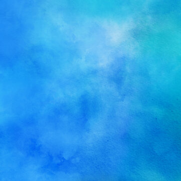 abstract watercolor background painting in blue cloudy colors with painted watercolor wash texture on paper