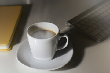 Hot cup of coffee on the desk