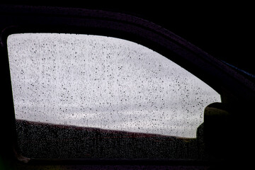 Windshield with raindrops on a rainy season or dropping day on a water proof gray reflection glass...