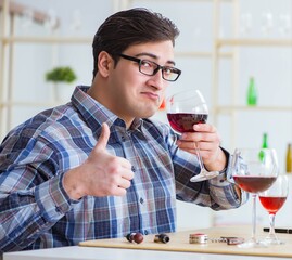 Professional sommelier tasting red wine