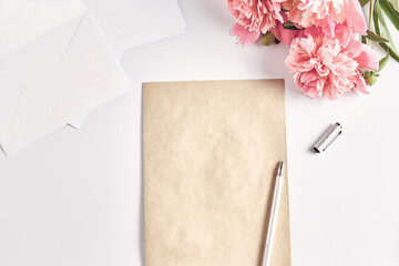 creative layout. office desk. home female workspace. a stack of envelopes and a notepad with a pen. flat lay, top view