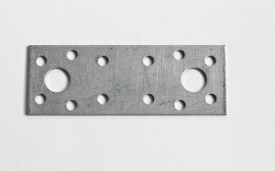 Construction metal part with holes on a white background.