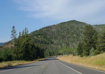 Cody, Wyoming, USA--July 2018: Sloping paved road at North Fork Highway to Yellowstone National Park east entrance.