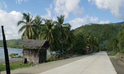 Fototapeta na wymiar Governor Generoso, Davao Oriental, Philippines-March 2016: Small huts along a coastal road in Davao Oriental.
