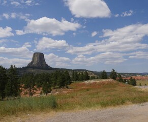 Wide view of the Devils Tower in Wyoming, America's first national monument, with gorgeous clouds...