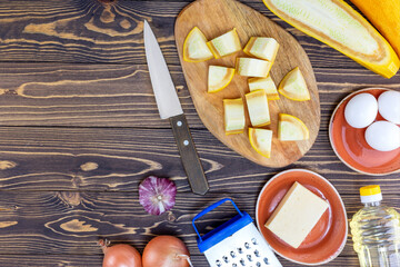 Italian mediterranean or greek cuisine. Preparing pizza with pesto, zucchini, mozzarella cheese and egg.