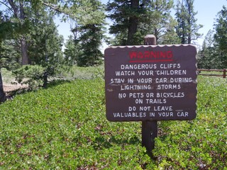 Wide view of a concrete warning sign at Yovimpa Point, one of the breathtaking scenic points at Bryce Canyon National Park.