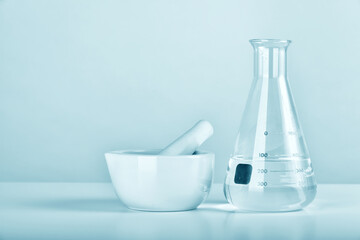 Group of scientific laboratory glassware and mortar with clear liquid solution, Research and development concept.