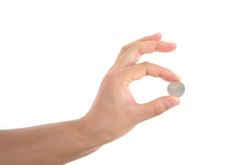 A hand holding a coin in front of a white background