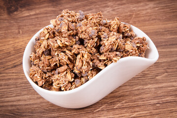 Oat flakes or granola with chocolate containing iron and fiber, healthy snack concept
