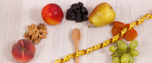 Centimeter with spoon and healthy nutritious food as source minerals, vitamins and fiber, slimming concept