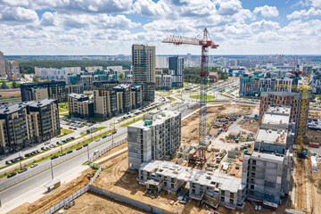 Fototapeta premium aerial view of construction site of a new residential area with tower cranes
