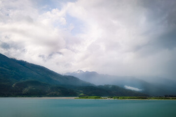 Fog lifting up at Lake Wanaka - Dramatic alpine range view in Mount Aspiring National Park, Otago Region, New Zealand, Southern Alps.