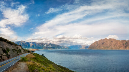 Fototapeta na wymiar Lake Hawea Lookout Panorama in beautiful late afternoon light with mountain peaks in the distance in Mount Aspiring National Park, Otago Region, New Zealand, Southern Alps.