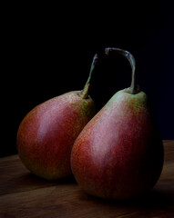 Two beautiful ripe pears on a wooden table.
