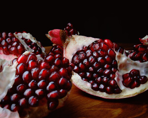 Ripe tasty pomegranate on a wooden table.