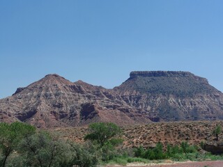 Beautiful landscape and layered rock formations with flat peaks at Zion National Park in Utah, USA.