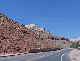 Winding paved road with land formations at Zion National Park, Utah, USA.