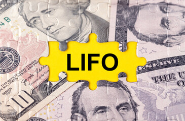 Puzzle with the image of dollars in the center of the inscription -LIFO