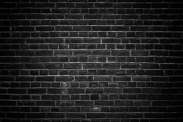Black wall brick background with vignetting.
