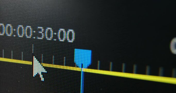 Blue slider moves along yellow timeline while film editor works with video sequence in computer program macro view