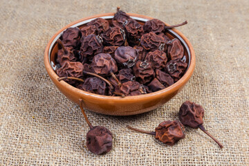 Dried wild pears in bowl on the burlap, close-up