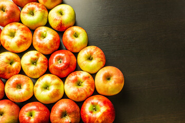 Fresh apples on a dark wooden background.