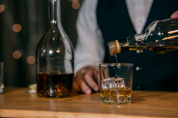 Barman pouring whiskey whiskey glass beautiful night