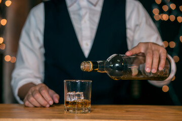 Barman pouring whiskey whiskey glass beautiful night