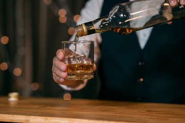 Whisky is poured into glass Beautiful bokeh