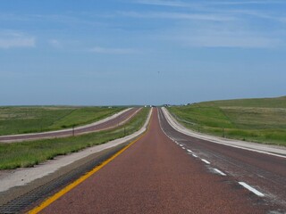 Straight paved red asphalt at Powder River Road in Gillette, Wyoming