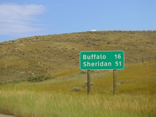 Roadside sign with distances to Buffalo and Sheridan, Wyoming.