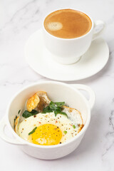 fried egg with herbs and black coffee for breakfast.
